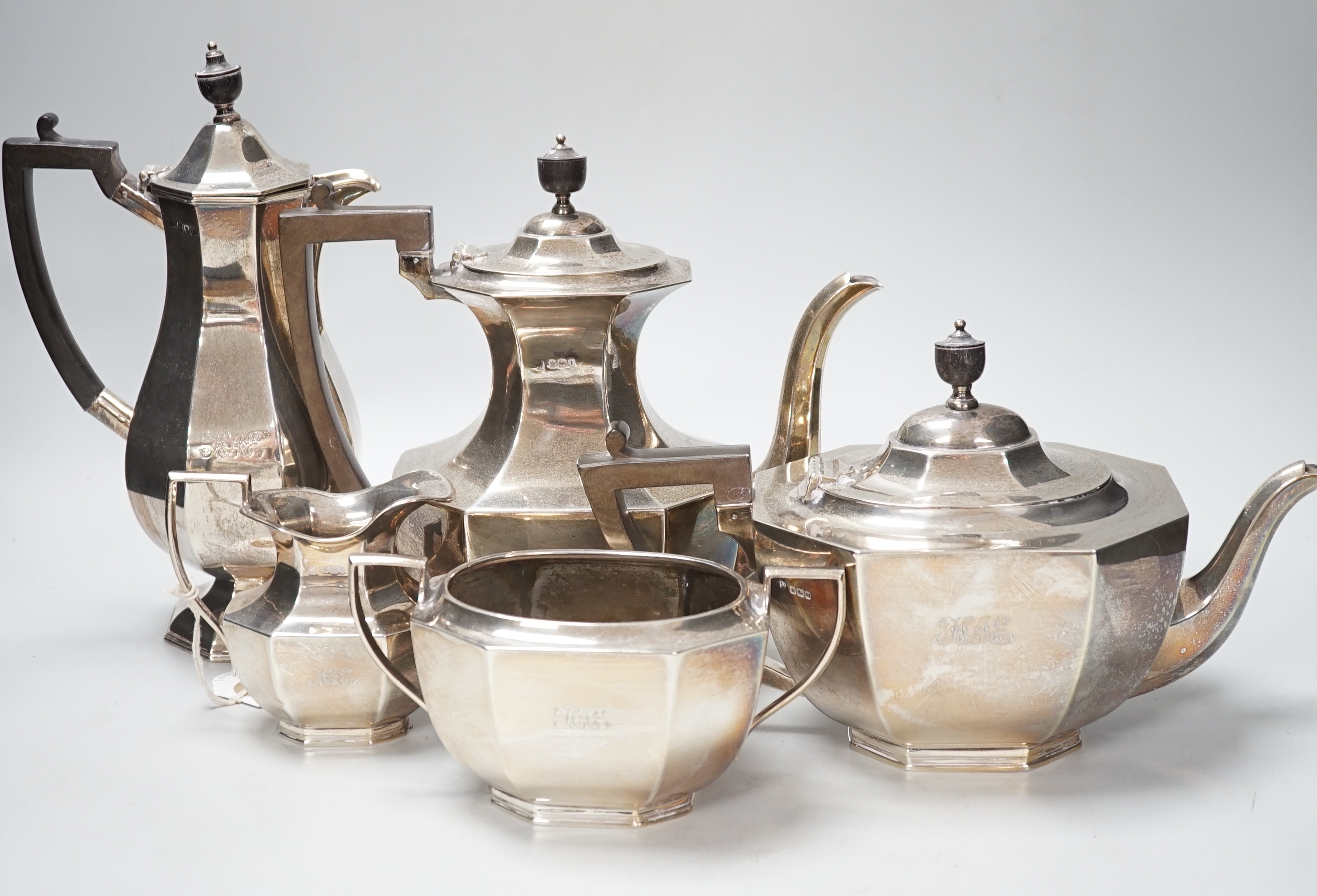 A George V panelled silver four piece tea and coffee service, Fordham & Faulkner, Sheffield, 1911 and a similar hot water pot, Hawksworth, Eyre & Co Ltd, London, 1912, gross weight 79.3oz.